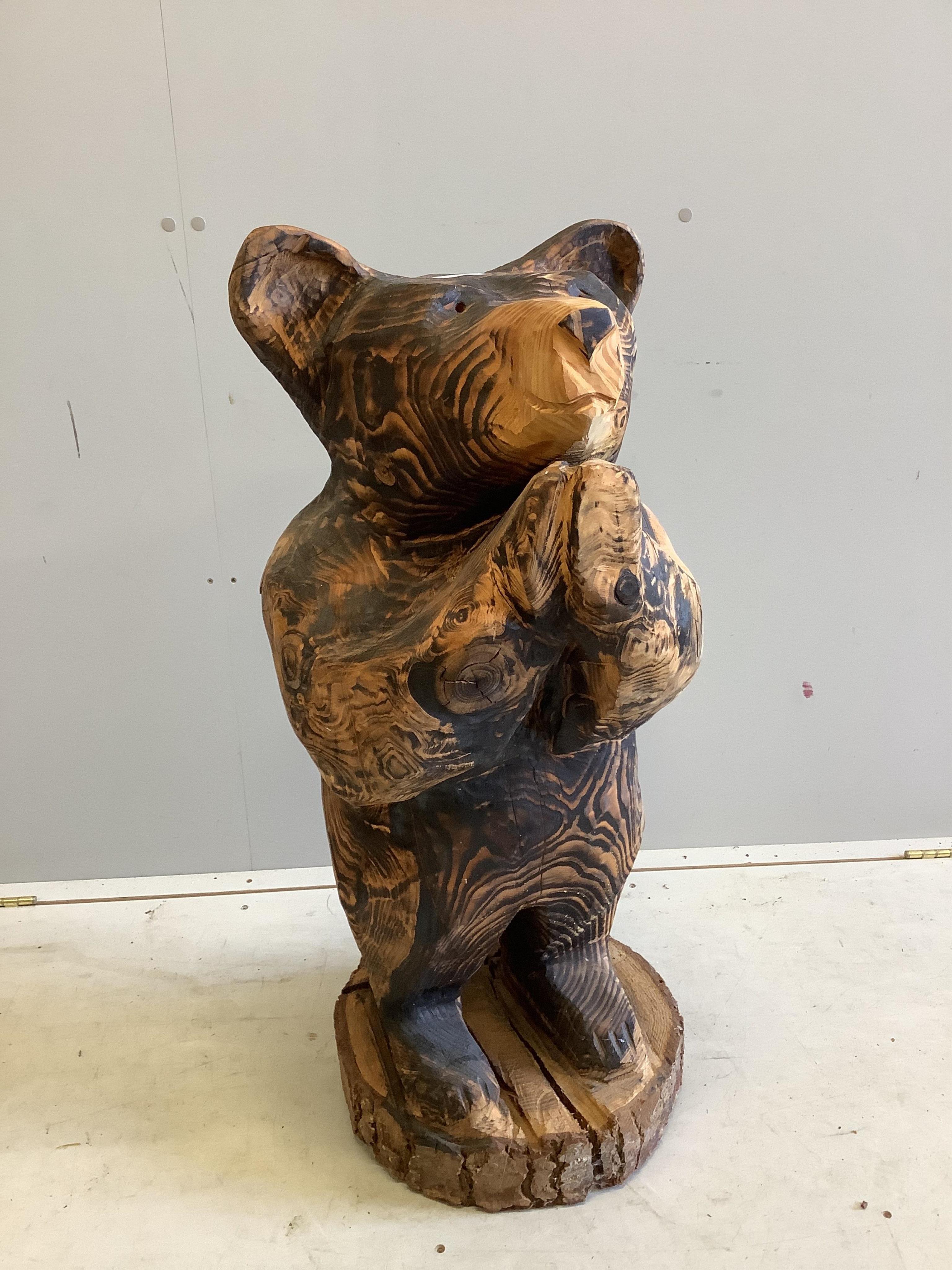 A garden chain saw carving of a standing bear together with a painted reconstituted stone Captain Manwaring garden ornament, larger height 93cm. Condition - fair